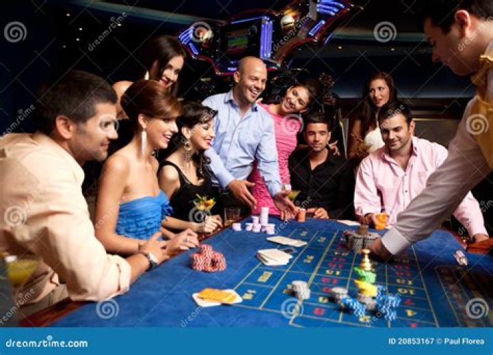 Happy friends play roulette in a casino Happy friends play roulette in a casino